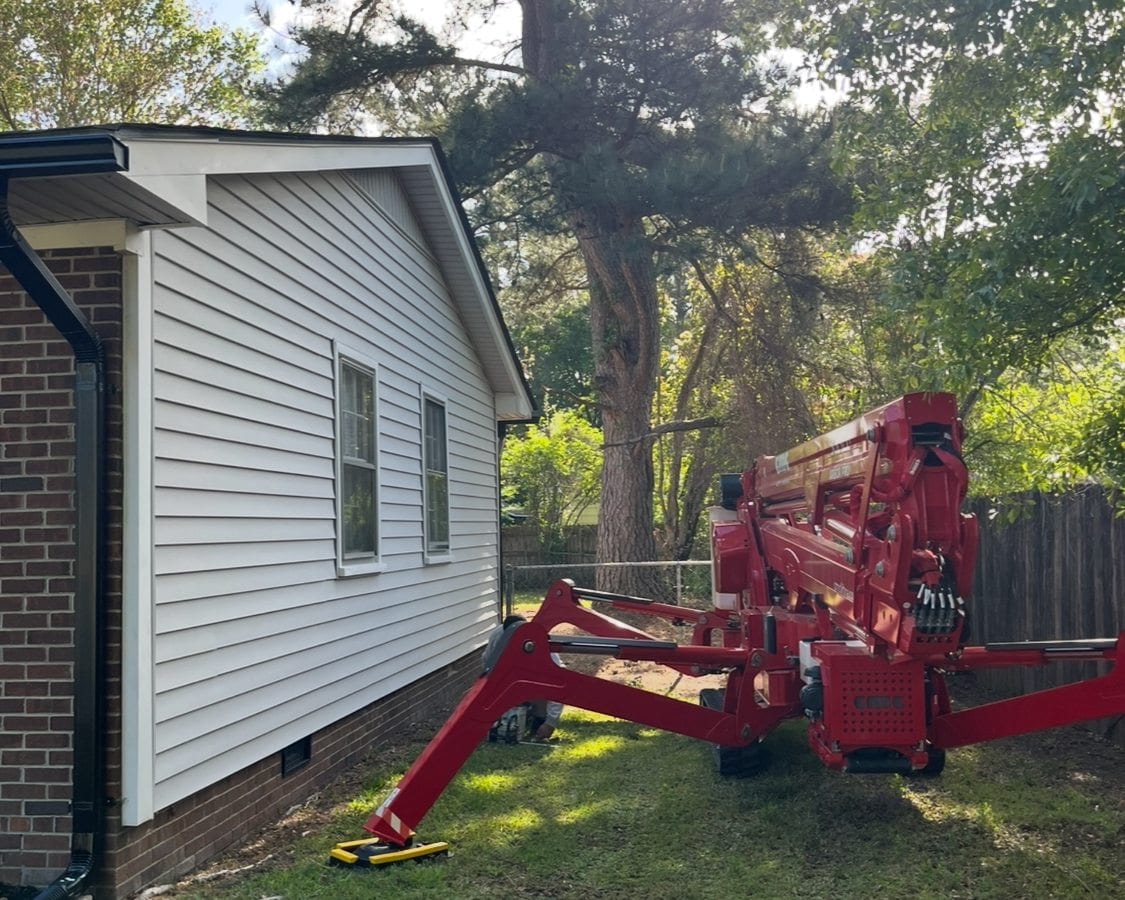 Spider lift set up next to a home for tight-access removal